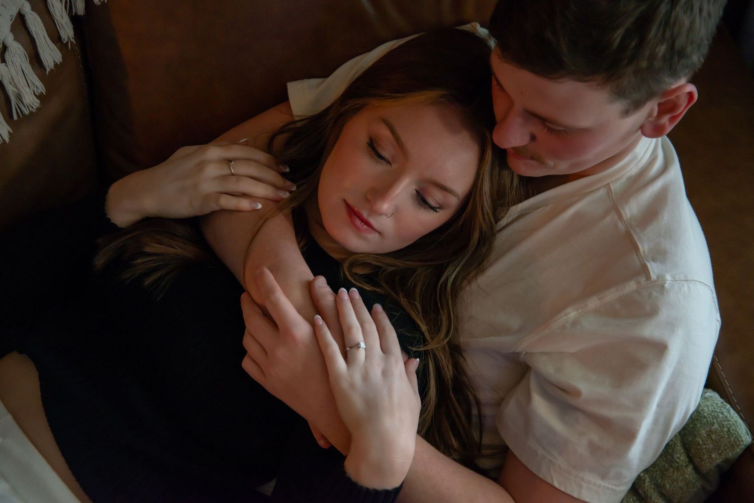 Indoor engagement photo with natural light. Kentucky lifestyle photographer captures candid love and cozy, heartfelt connection.