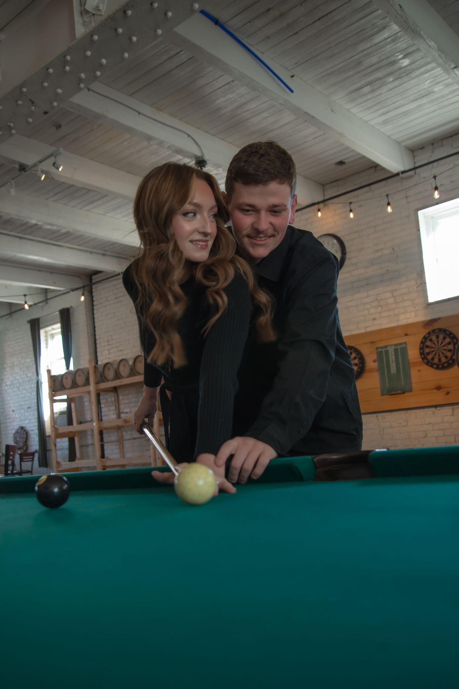 Indoor engagement photo with natural light. Kentucky lifestyle photographer captures candid love and cozy, heartfelt connection.