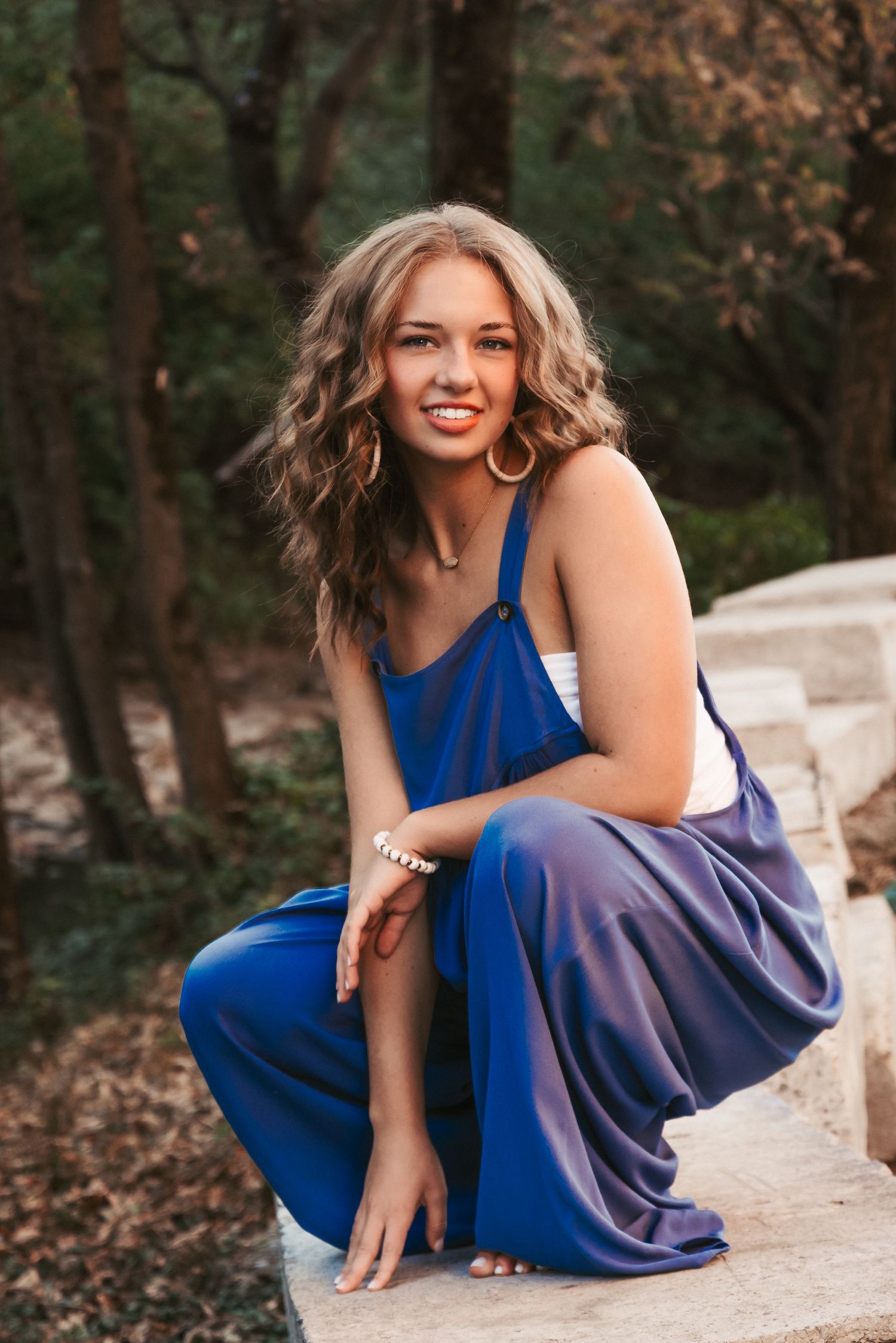 Senior portrait in natural outdoor setting during golden hour. Kentucky lifestyle photographer captures relaxed, authentic moments.