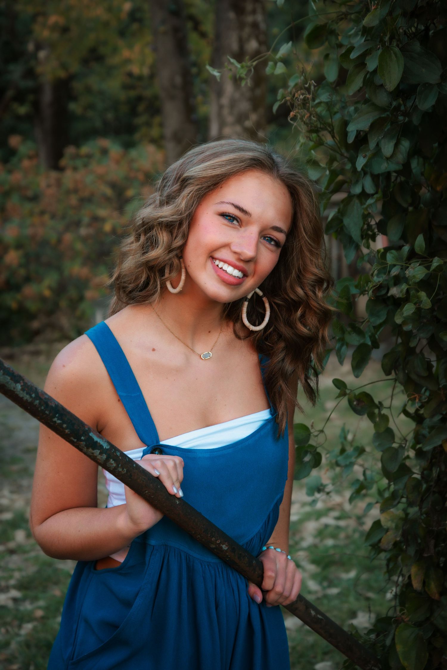 Senior portrait in natural outdoor setting during golden hour. Kentucky lifestyle photographer captures relaxed, authentic moments.