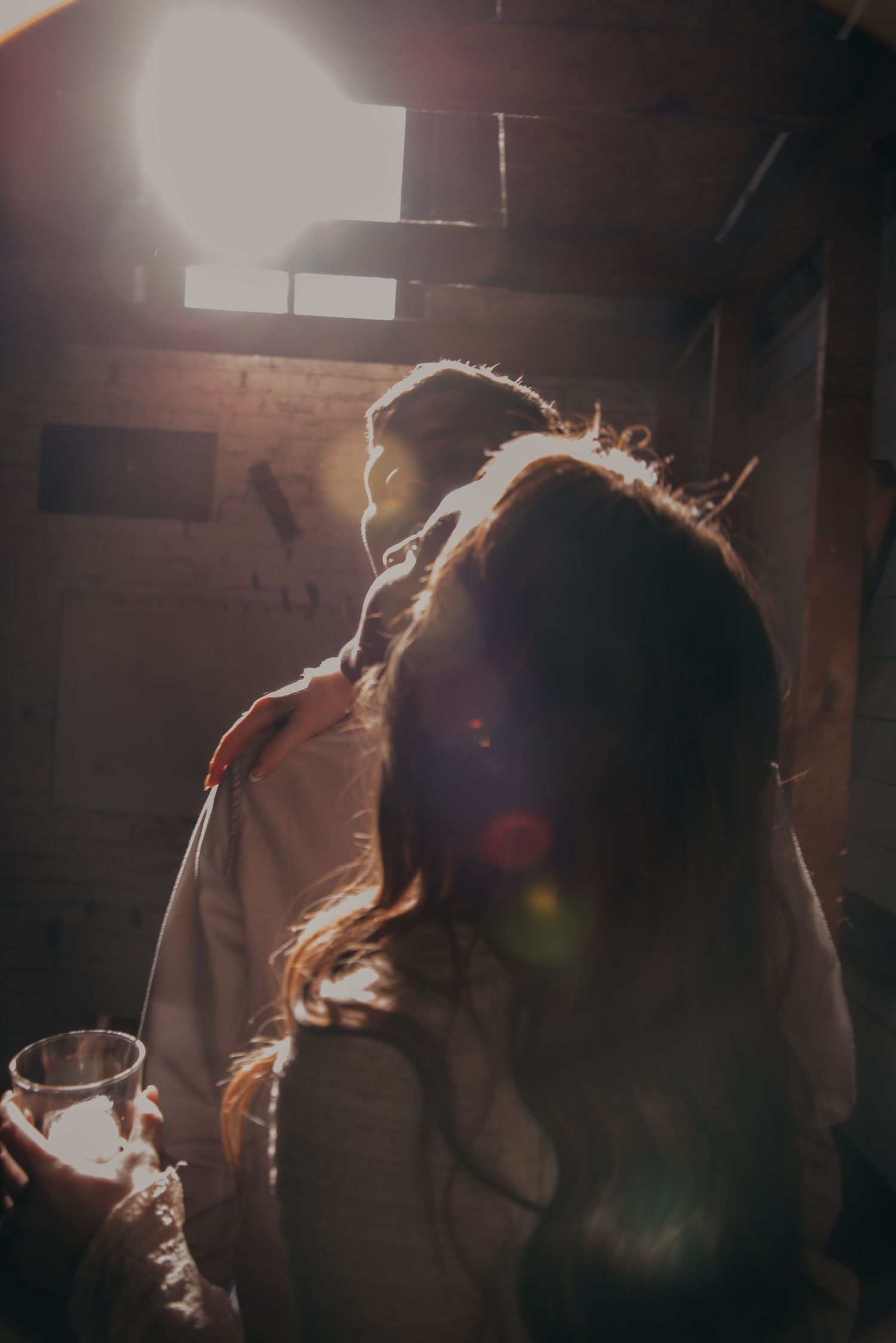 Indoor engagement photo with natural light. Kentucky lifestyle photographer captures candid love and cozy, heartfelt connection.