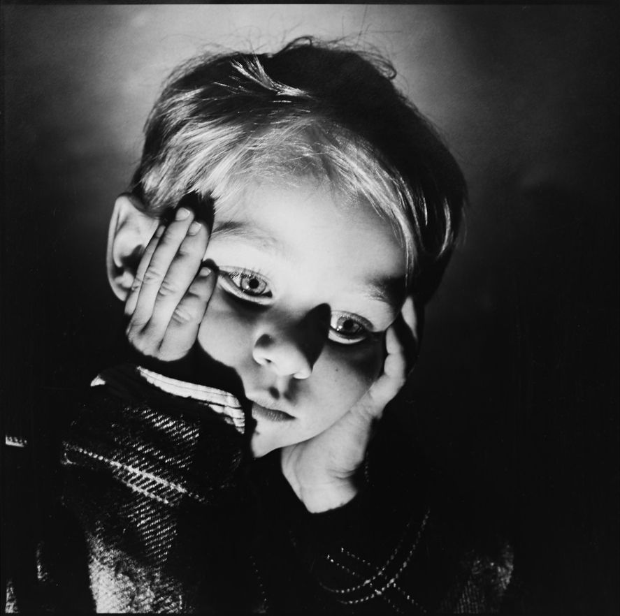 Dramatic black and white close-up shots with moody lighting and shadows.