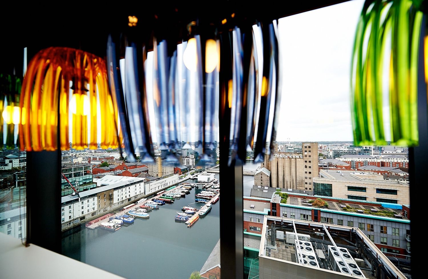 Panoramic view of modern office space with colorful curtains and city views.
