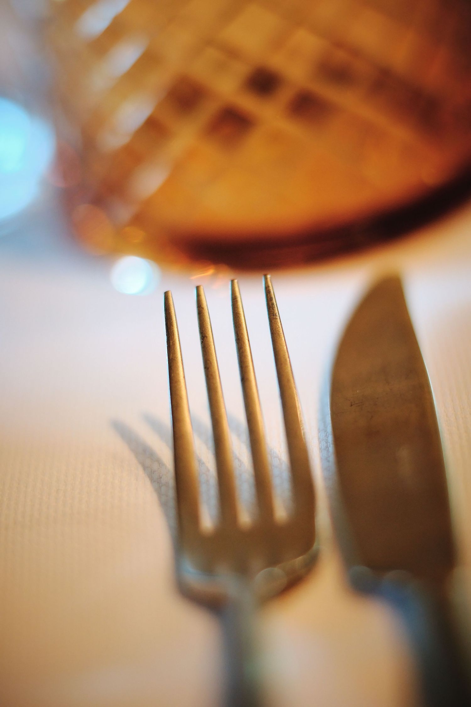Close-up of silverware with shallow depth of field focusing on fork tines.