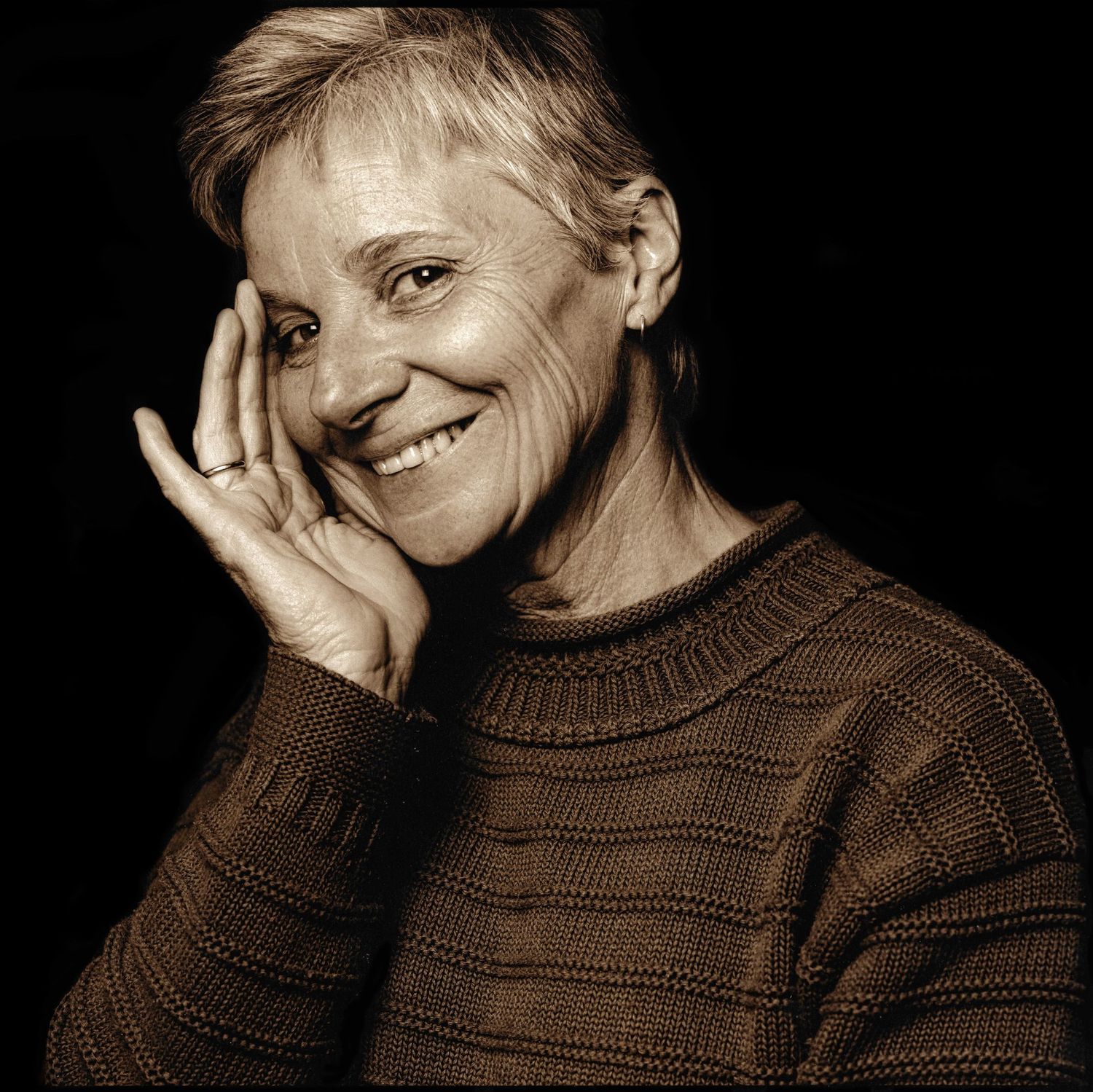 Sepia toned portrait sequence showing expressive emotions in a brown sweater.
