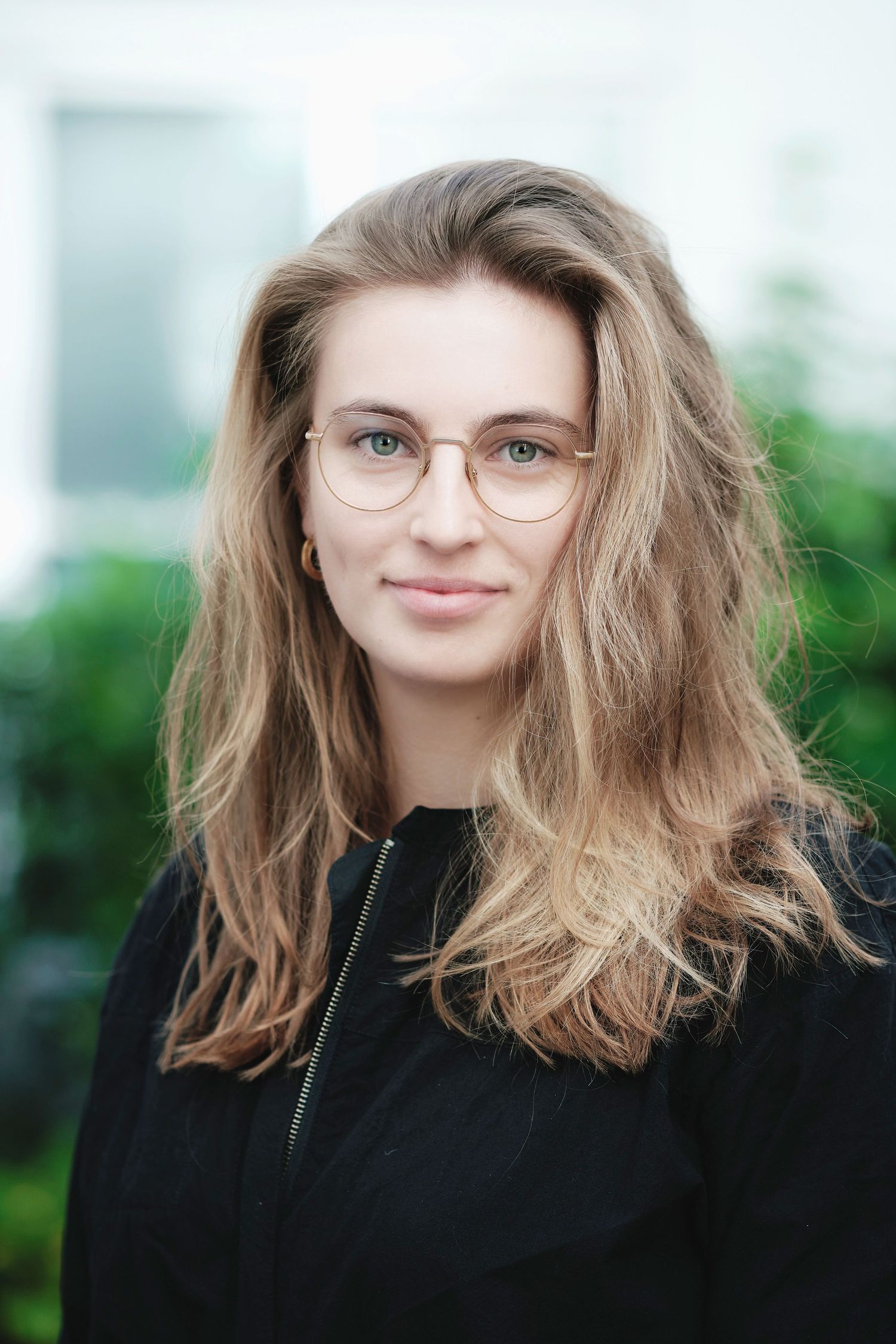 Professional portrait series with casual styling against bright background.