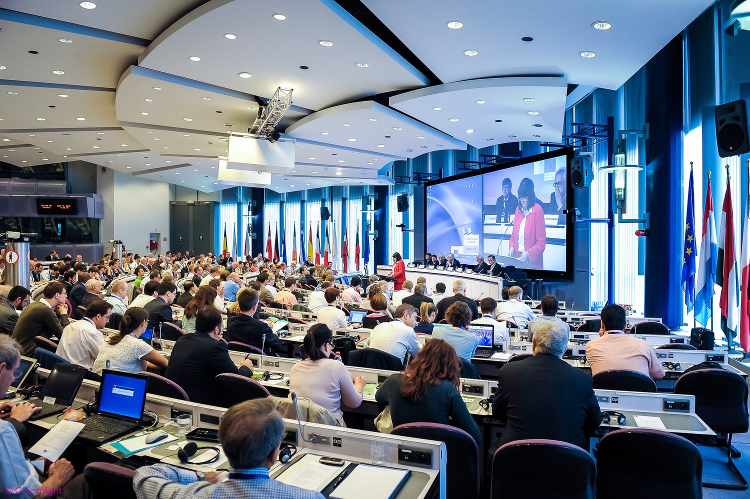 Modern conference room filled with attendees during a large-scale business meeting.