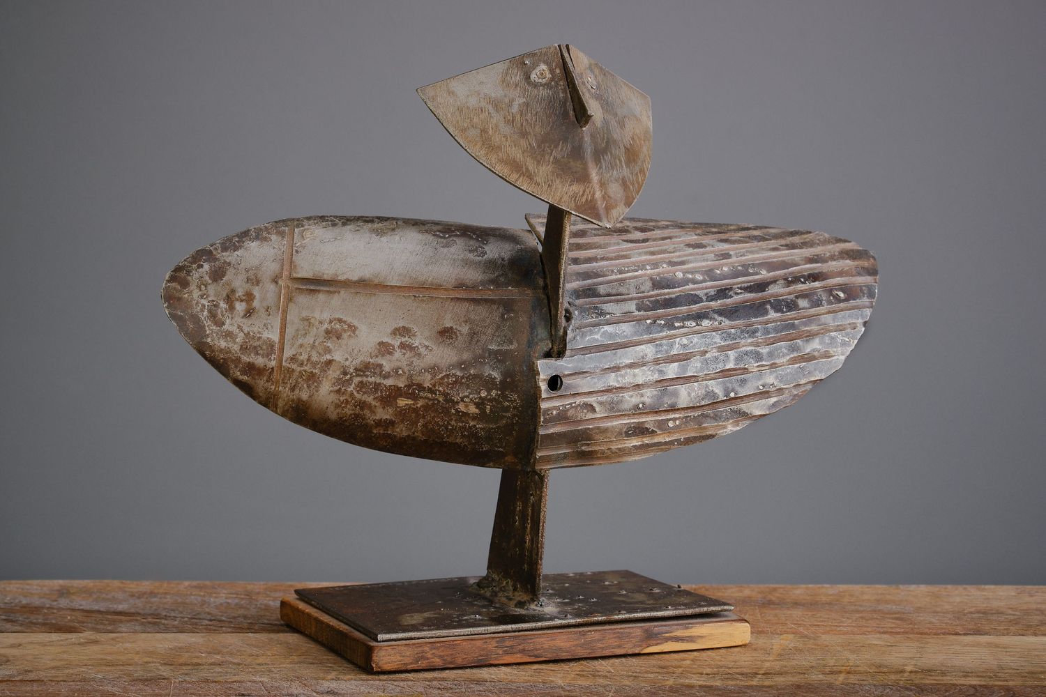 Collection of weathered wooden duck decoys arranged on a rustic surface.