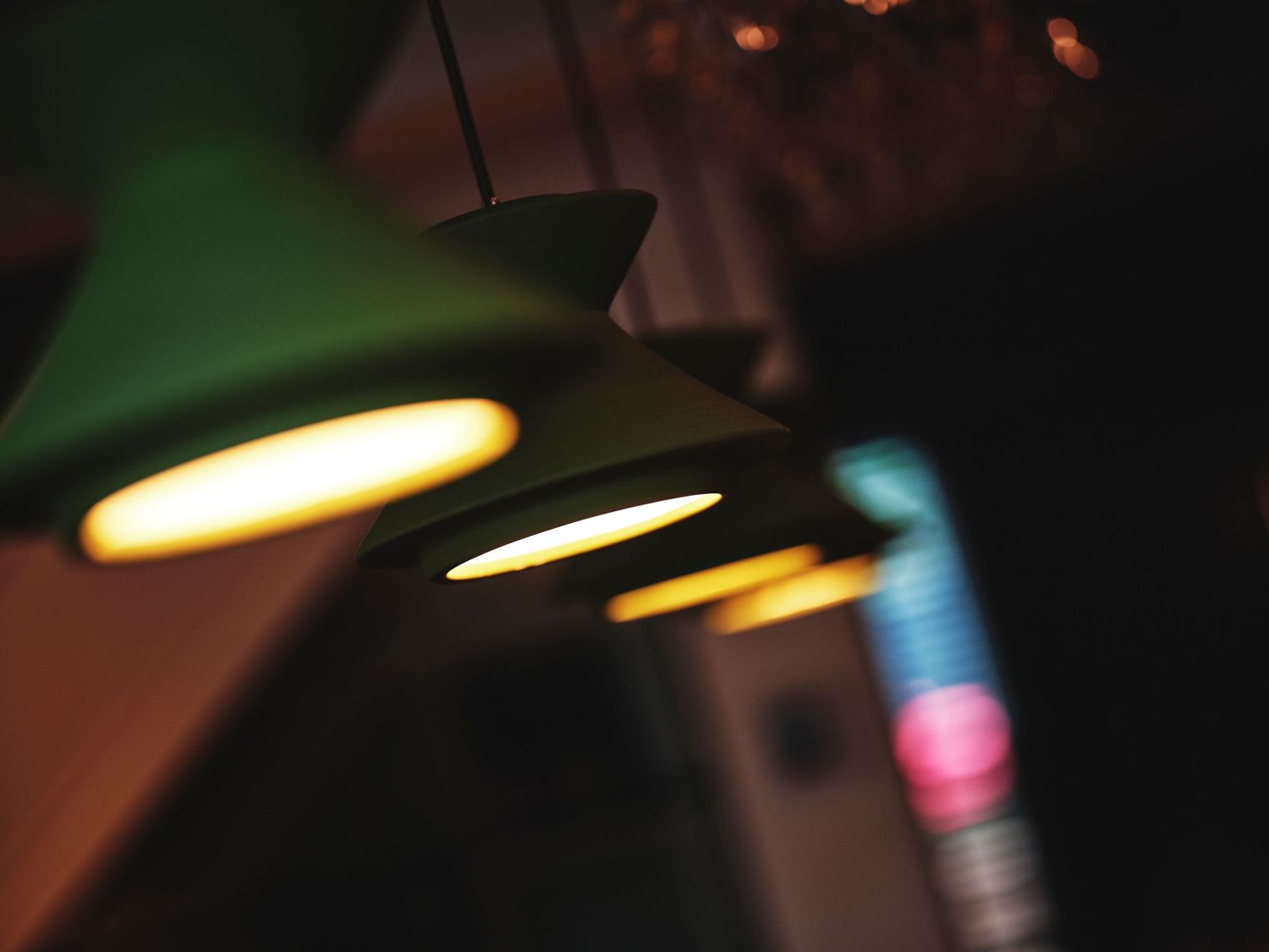 Dramatic lighting fixtures casting warm glows in a dark atmospheric setting.