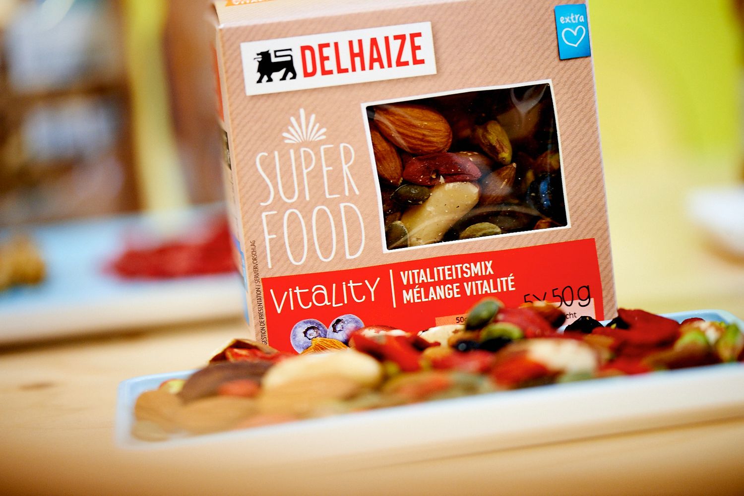 Delhaize superfood package containing healthy snacks displayed on wooden surface.