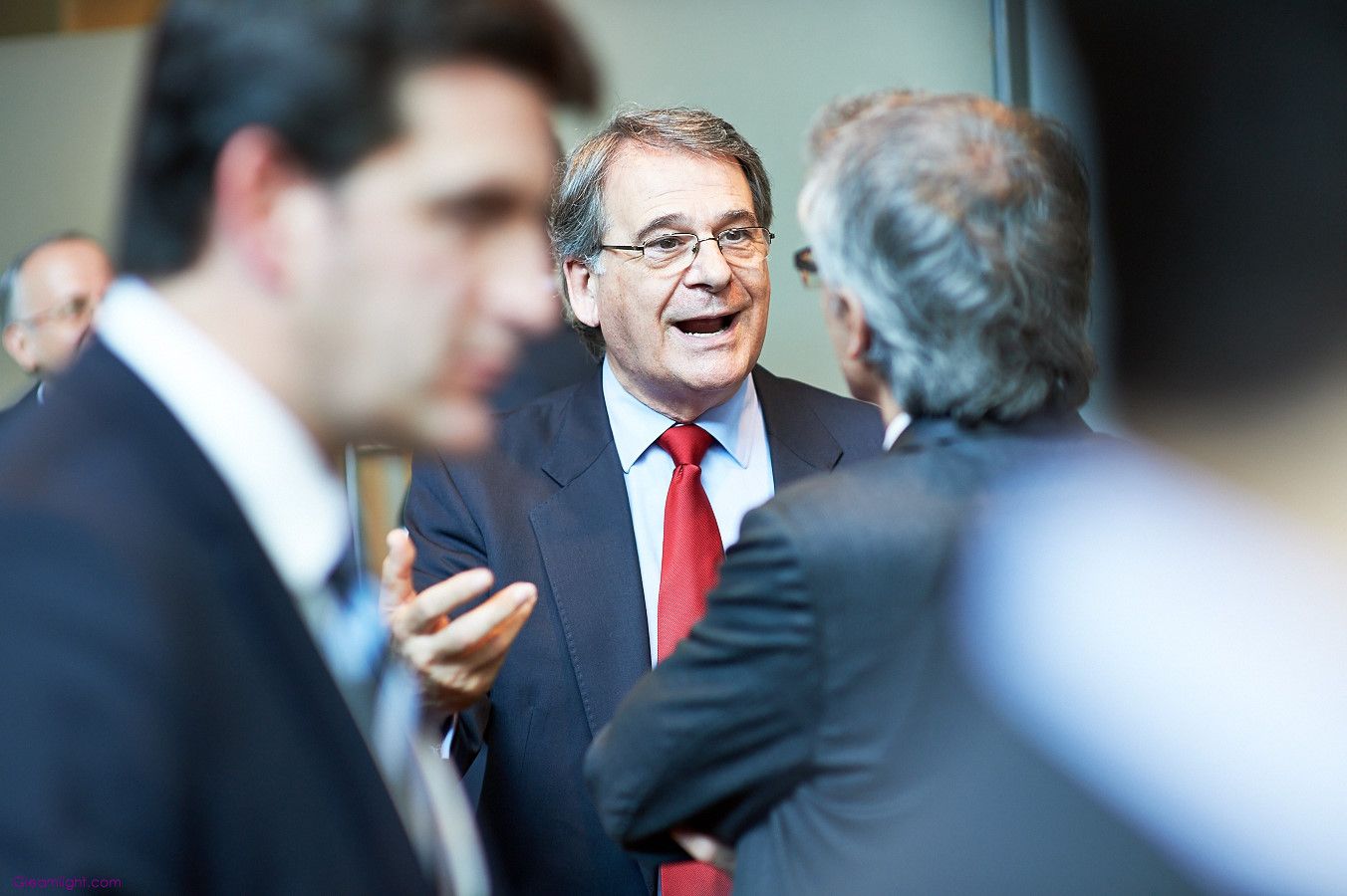 Business professionals engaged in animated discussion at a networking event.