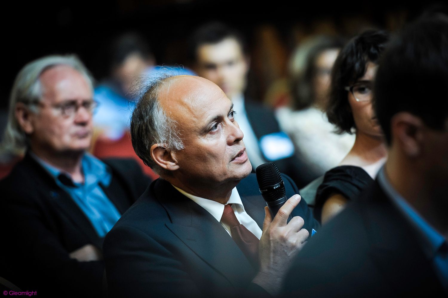 Business professionals engaged in conversation during a corporate event.