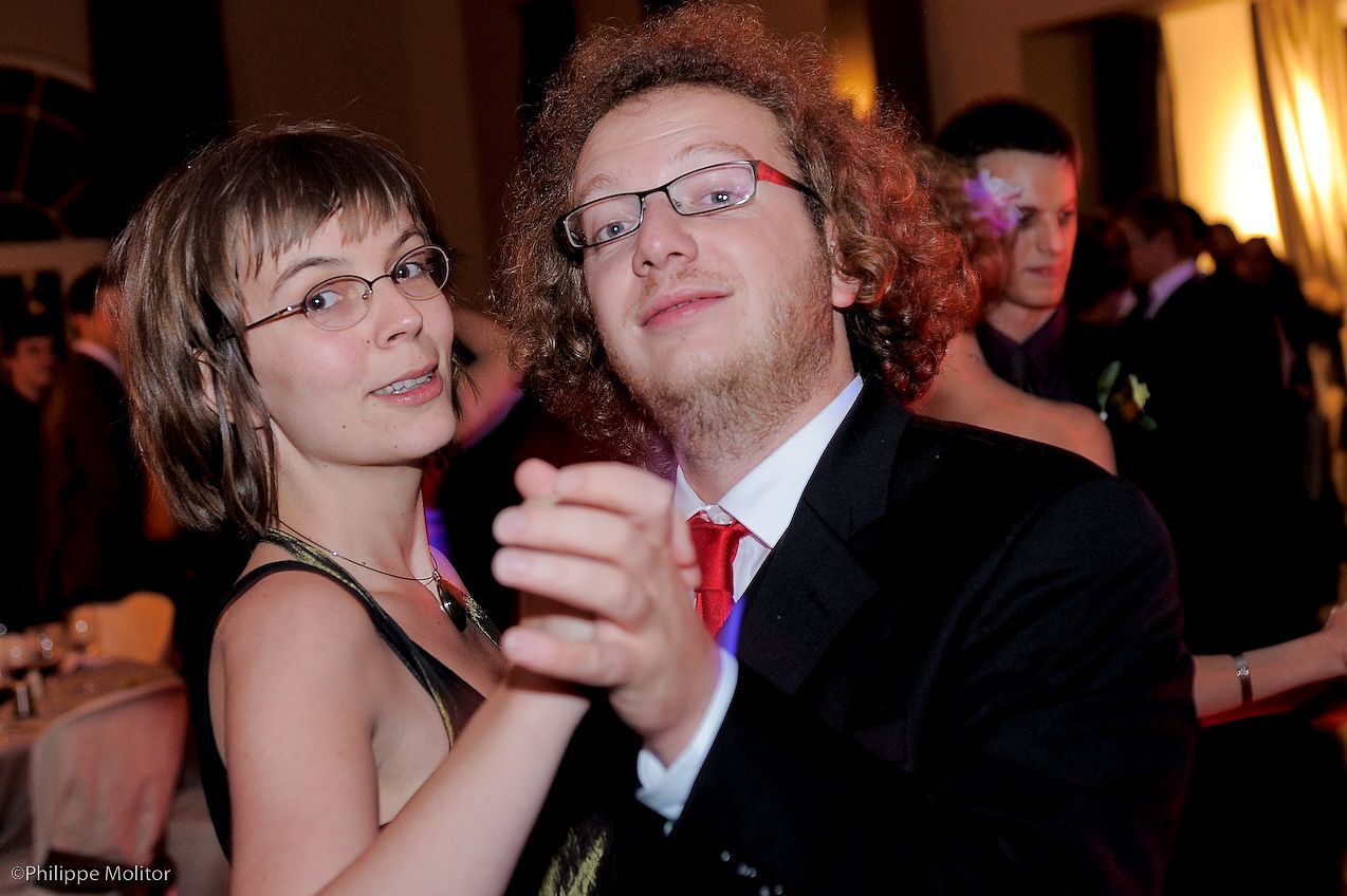 Young couple dancing together at a formal wedding reception event.