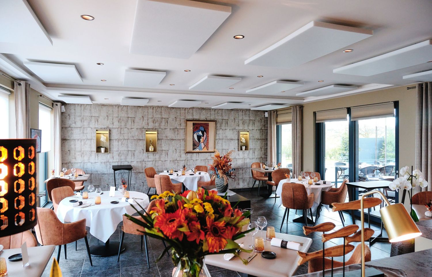 Spacious restaurant interior with orange accent lighting and modern ceiling design.