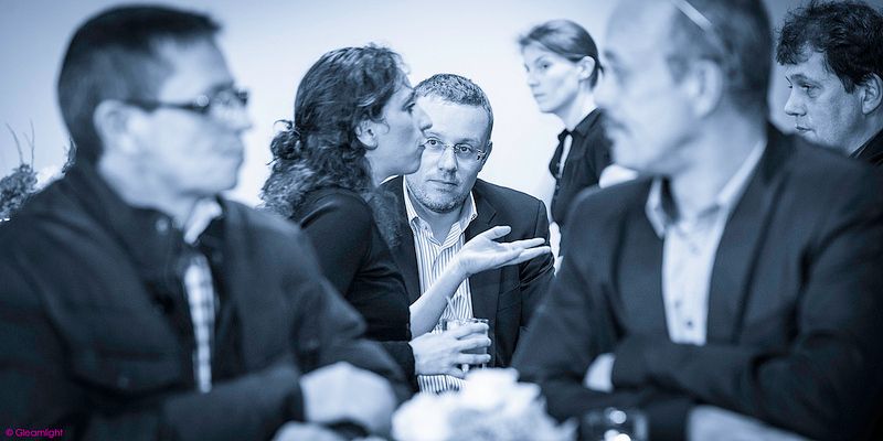 Business professionals engaged in discussion during a conference meeting.