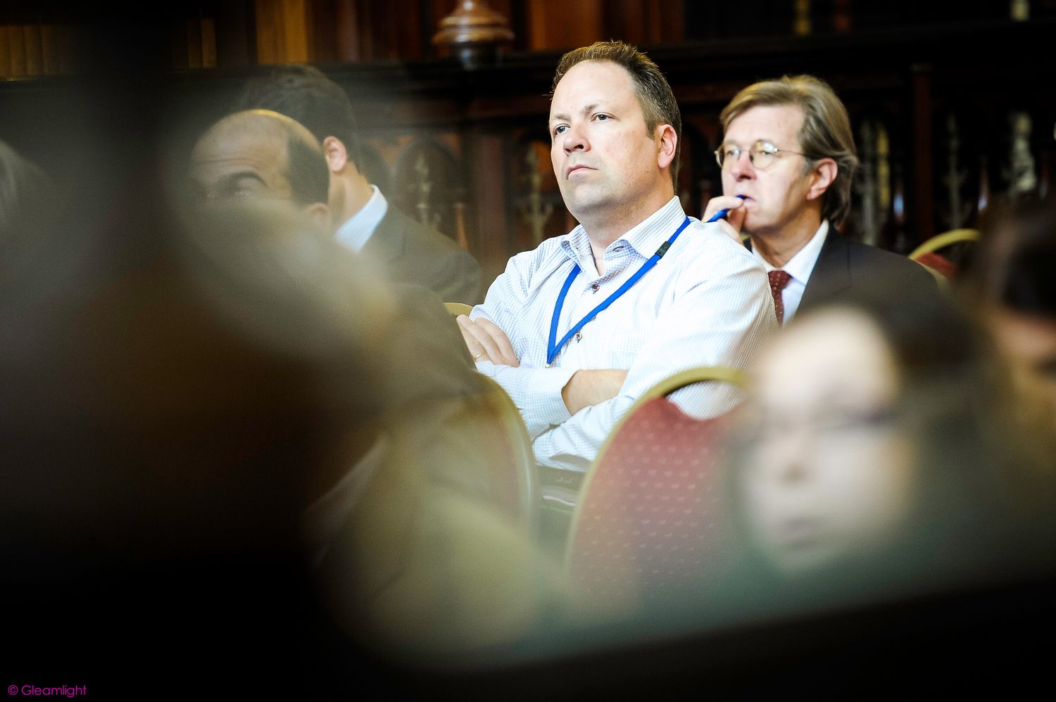 Conference participants engaged in discussion at a professional event.