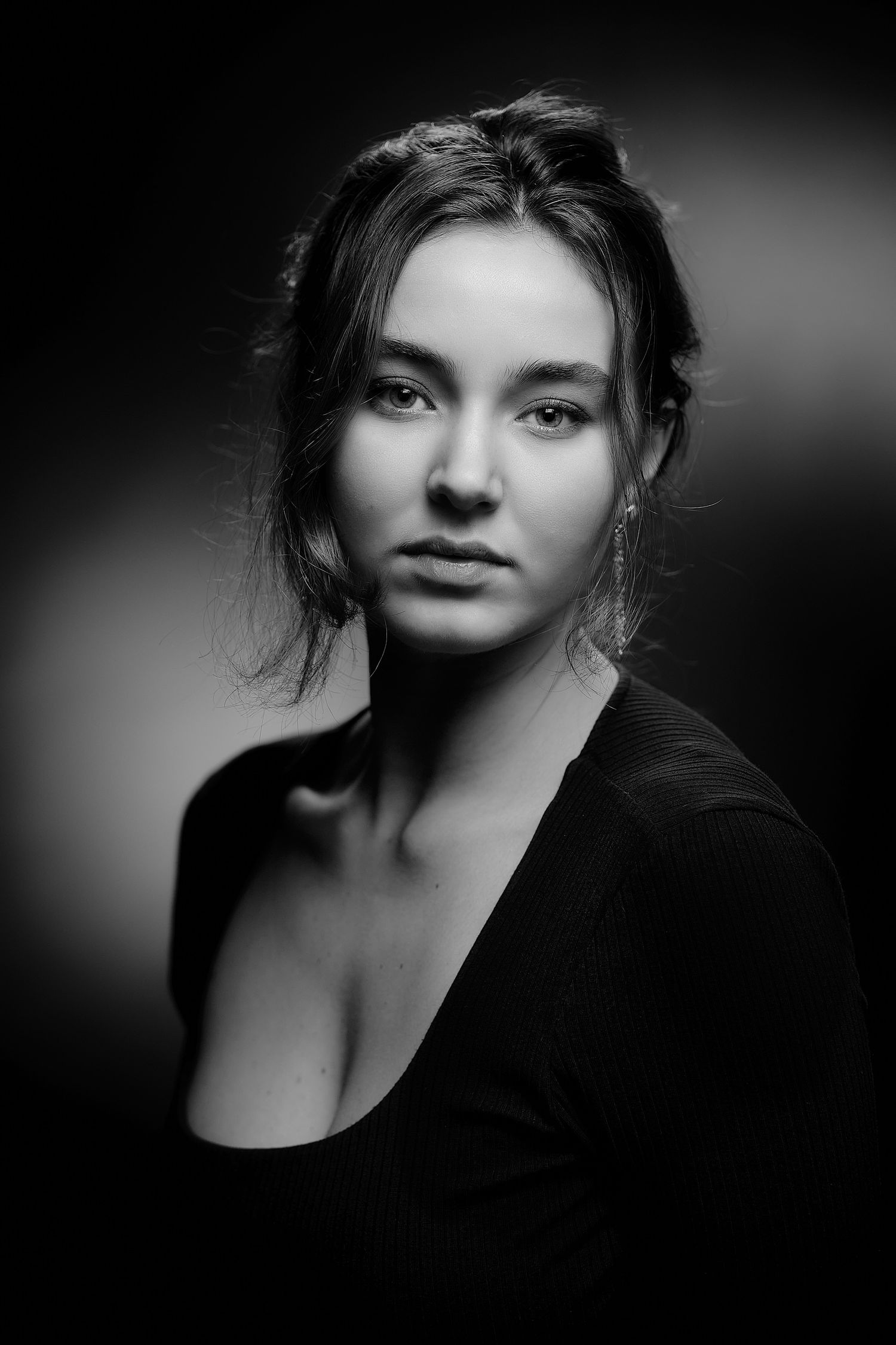 Moody black and white portrait series with dramatic shadows and lighting.