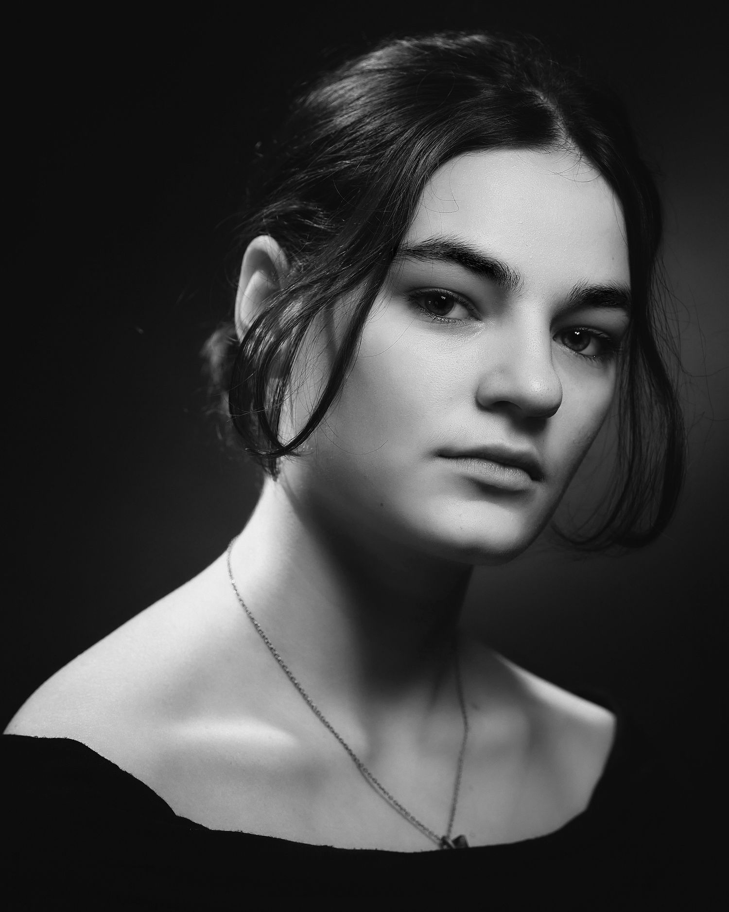 Artistic black and white portrait series with dramatic shadows and elegant composition.