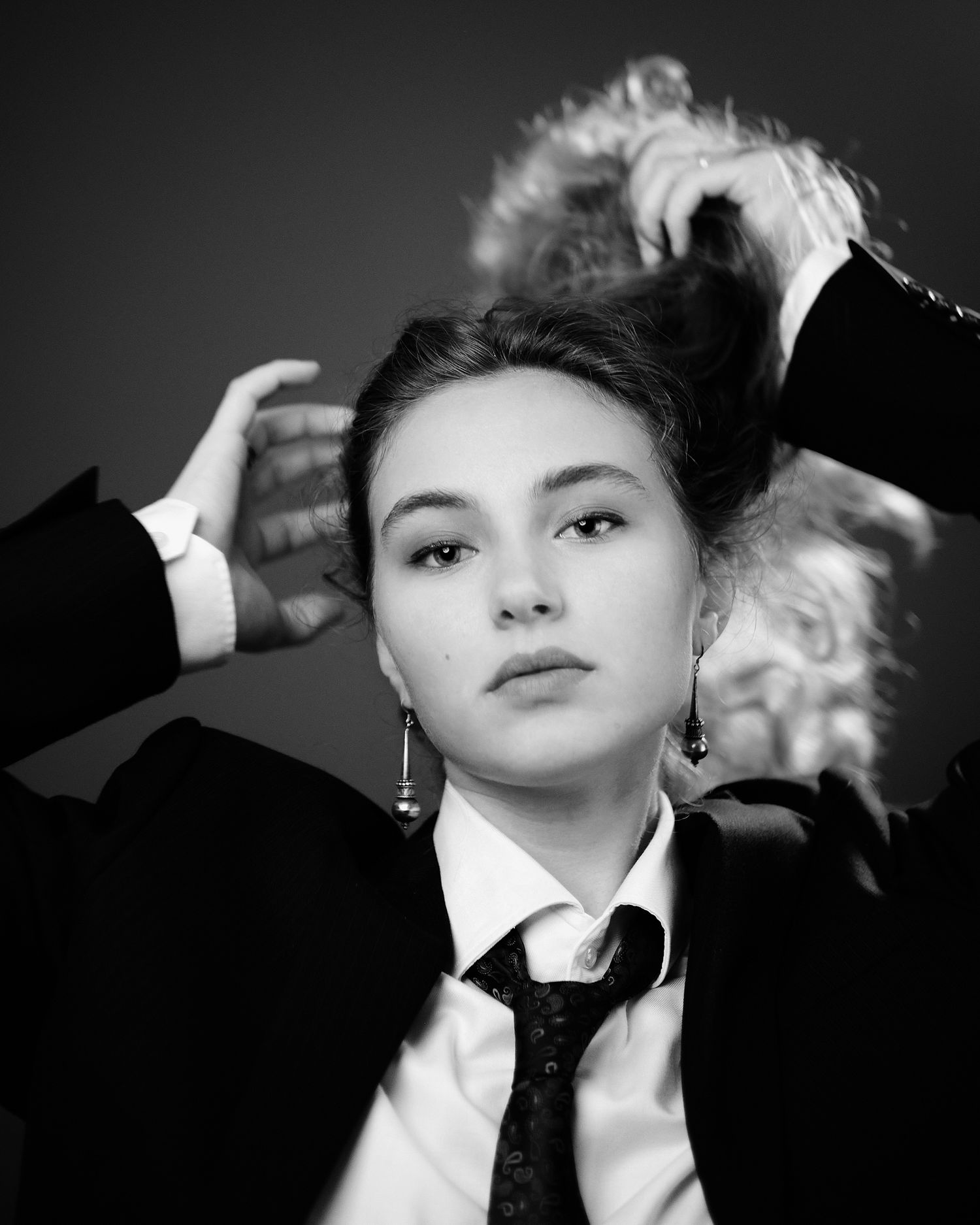 High contrast black and white portraits in formal wear with dramatic poses.