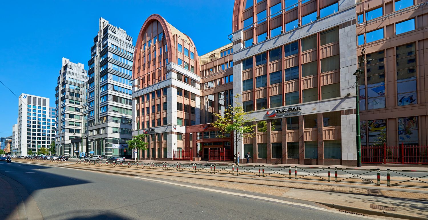 Red brick and glass office buildings with modern architecture in panoramic cityscape.