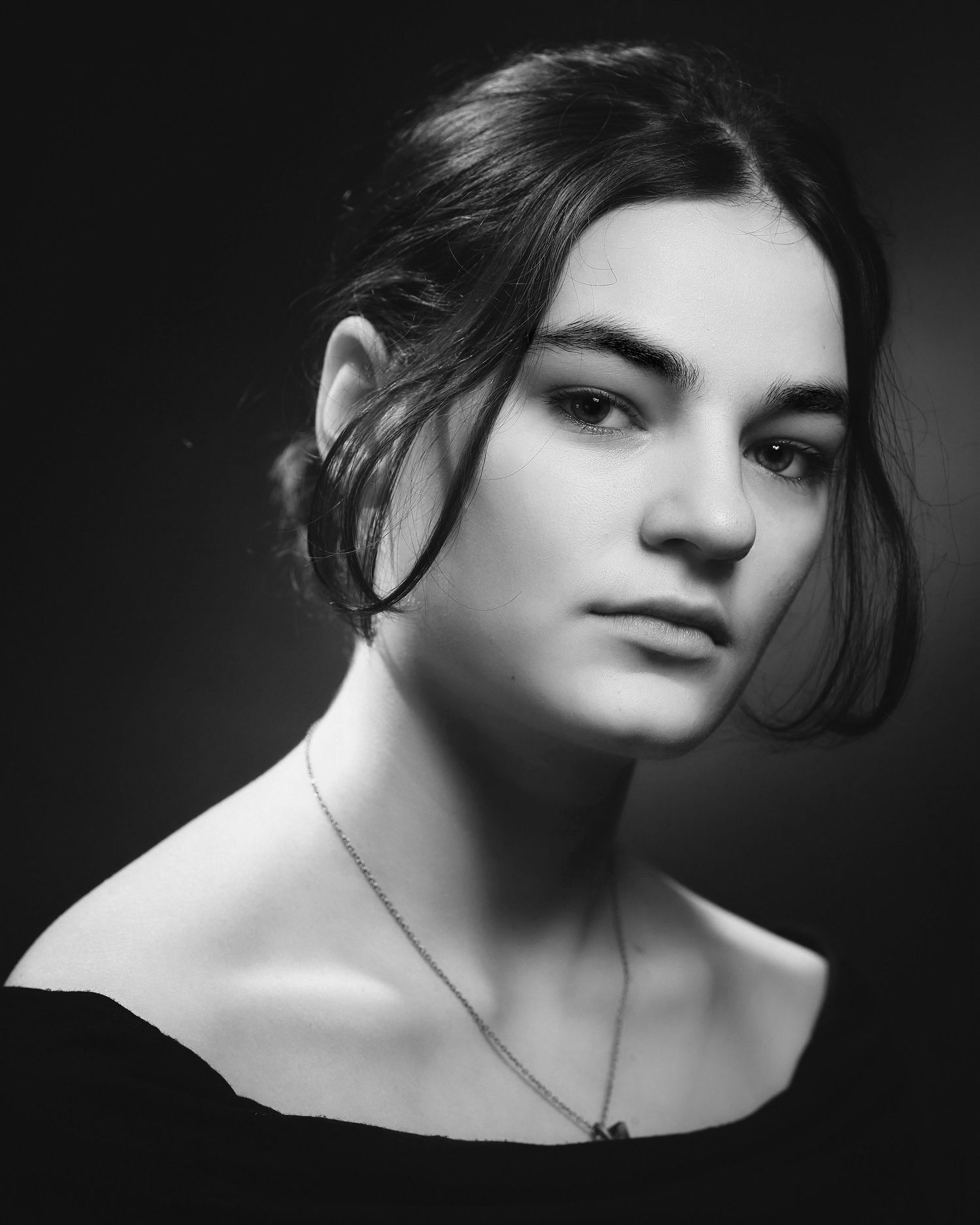 Artistic black and white portrait series featuring dramatic side lighting and shadows.