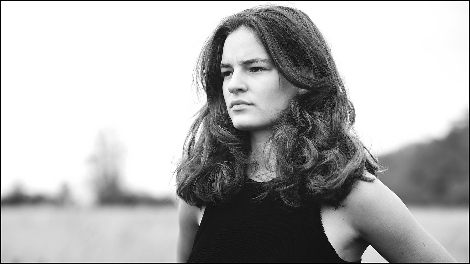 Artistic black and white panoramic portrait with dramatic side lighting.