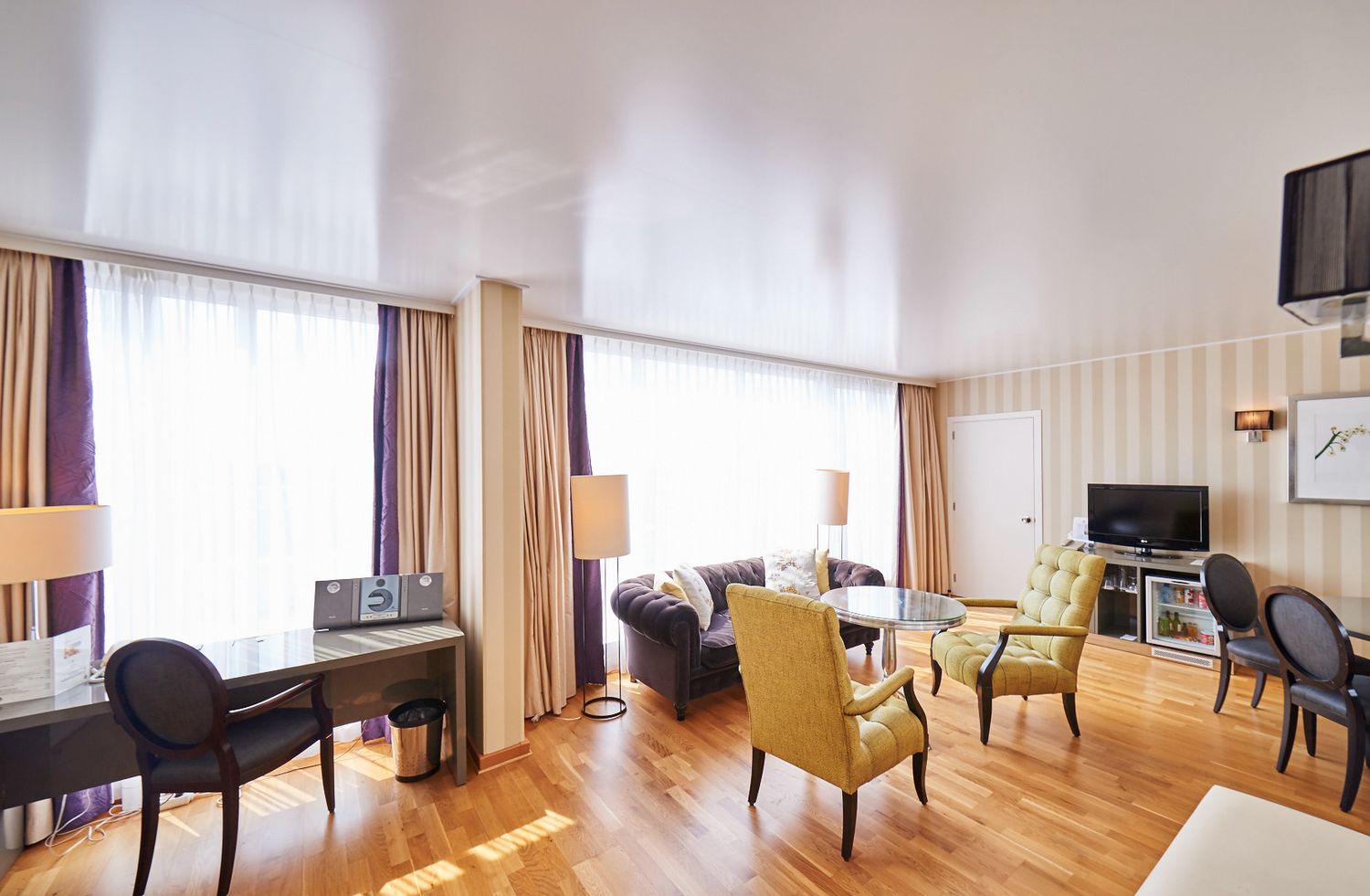 Spacious apartment living room with hardwood floors and contemporary furniture arrangement.