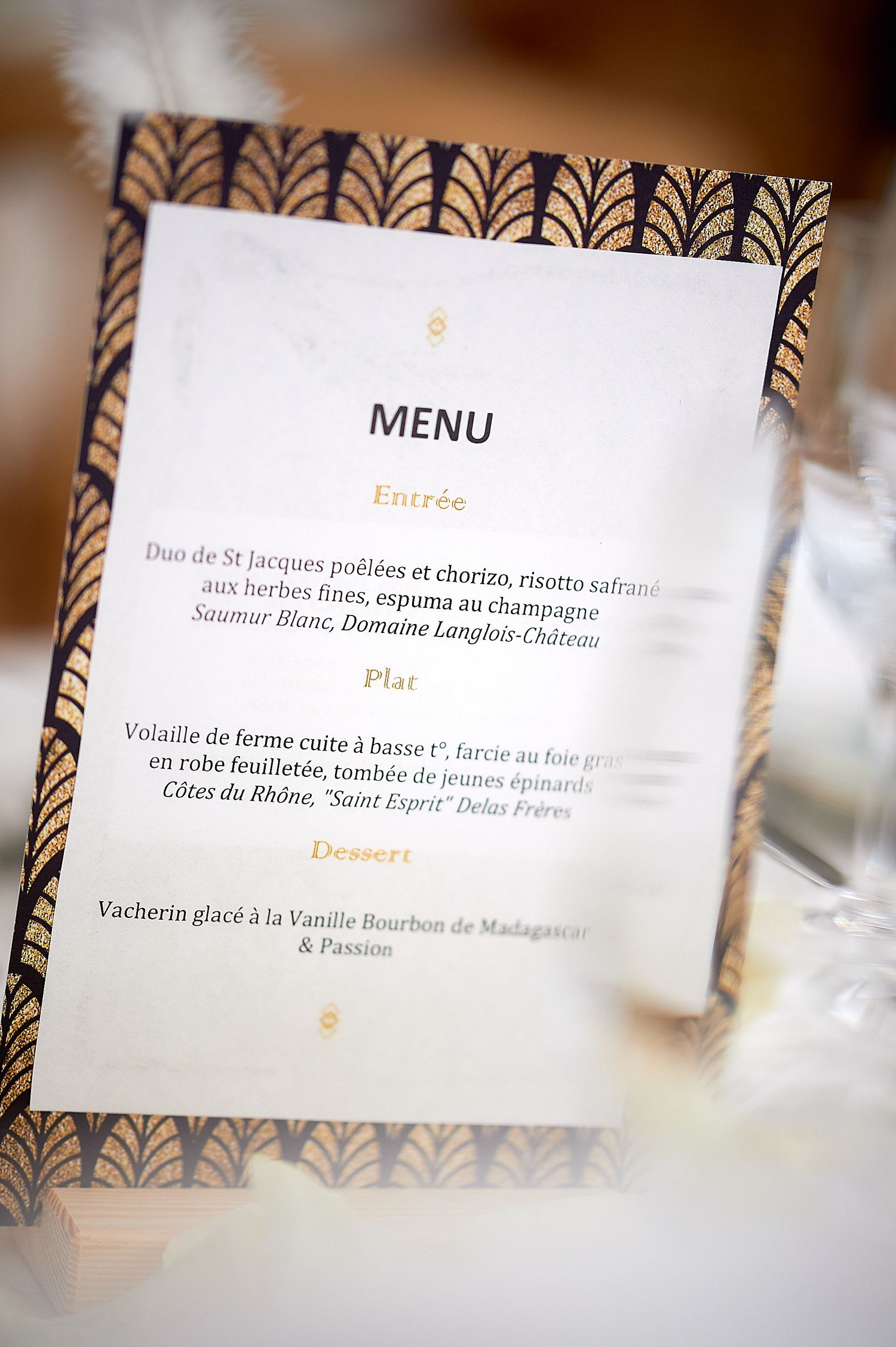 Elegant French wedding menu card with gold and black Art Deco border featuring entree, plat, and dessert courses.