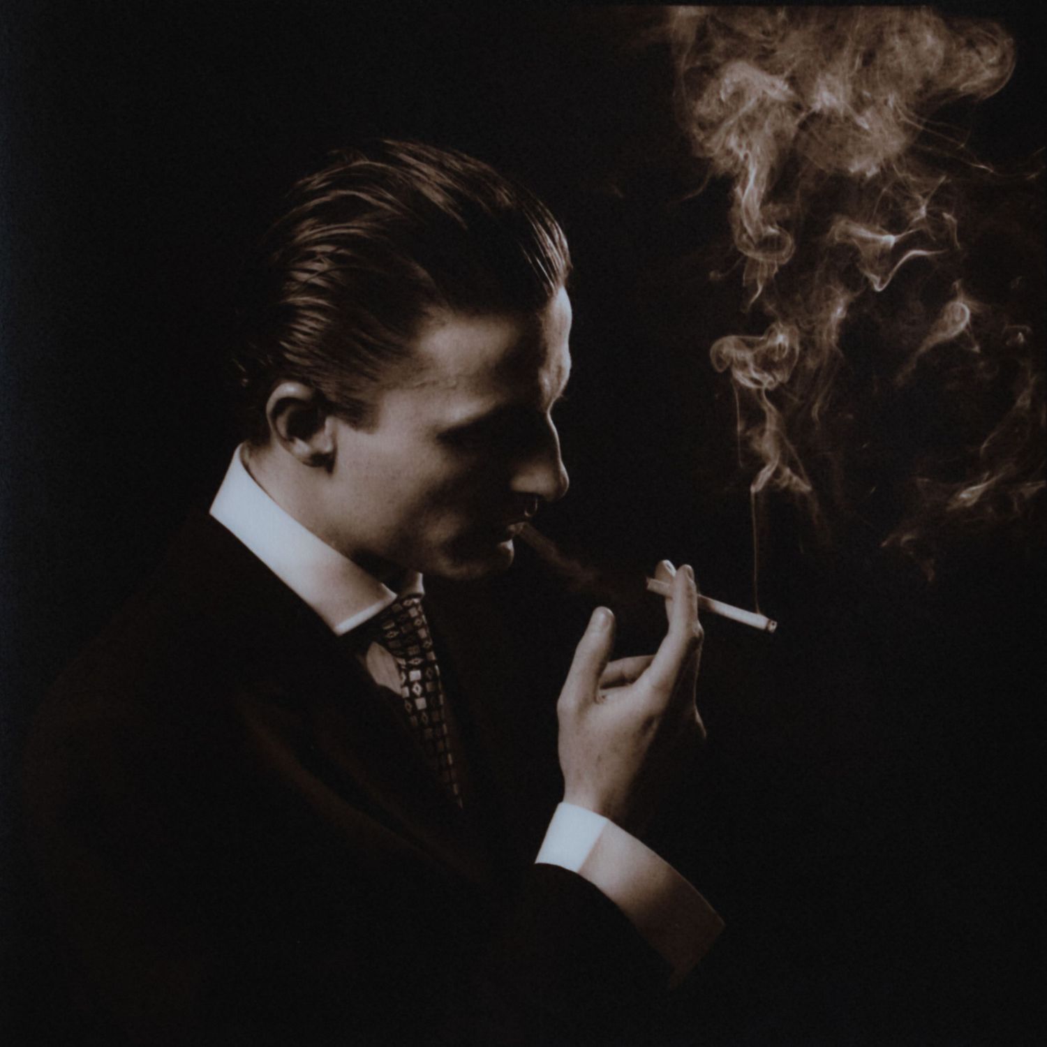 Noir-style photographs of silhouettes with cigarette smoke in dark lighting.