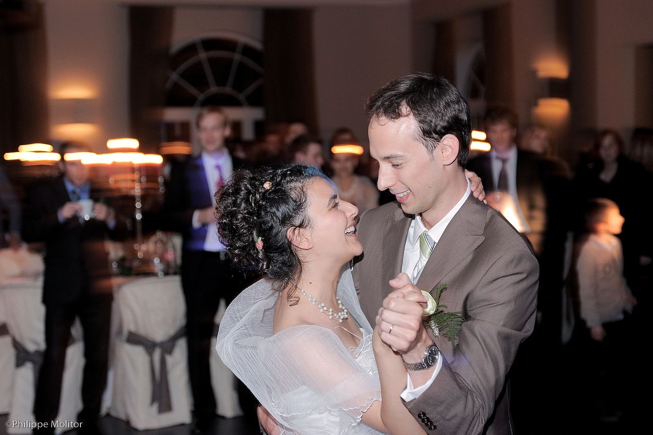 Bride and groom share their first dance at elegant wedding reception.