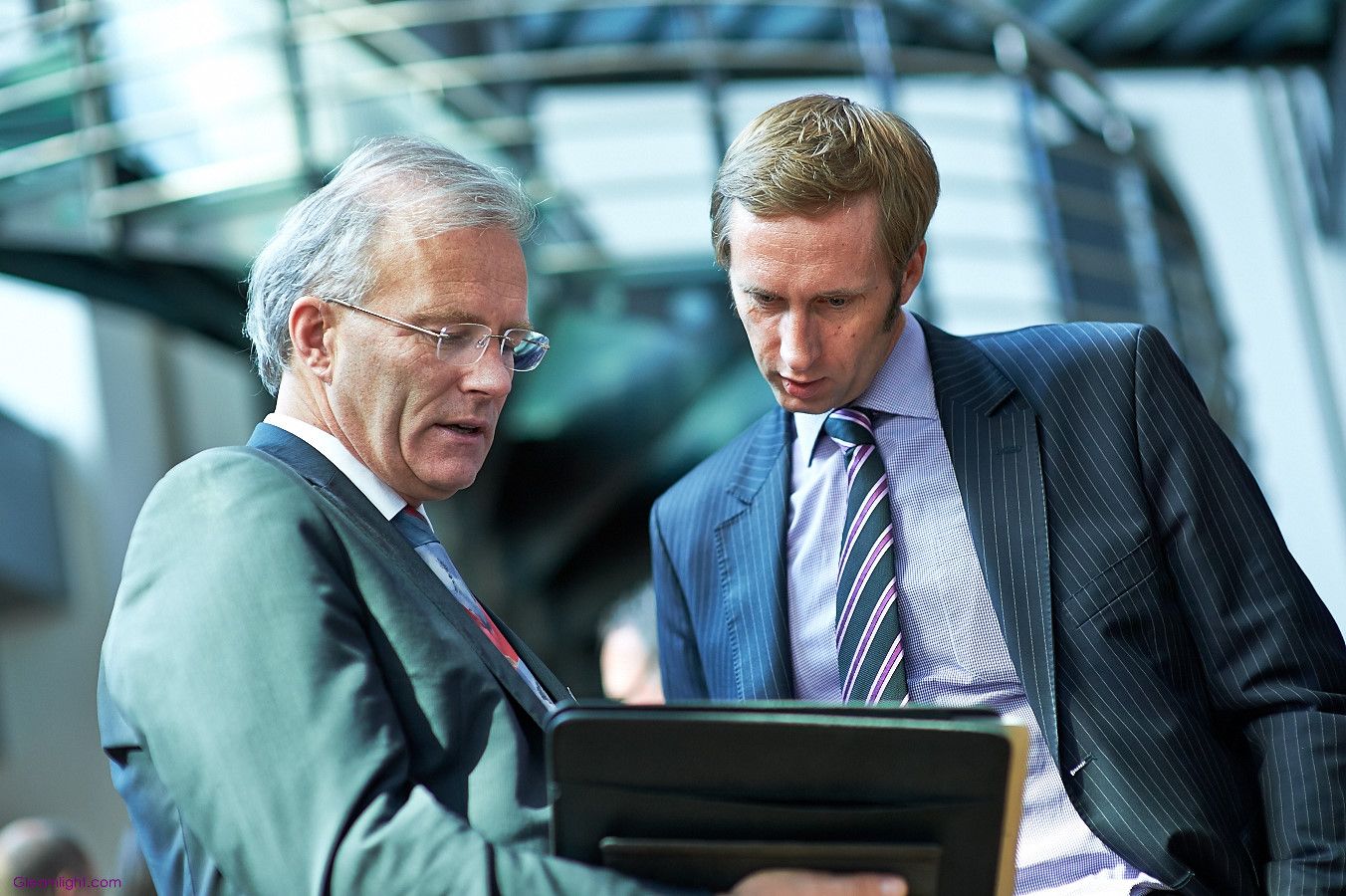 Business people reviewing documents together in a modern office environment.