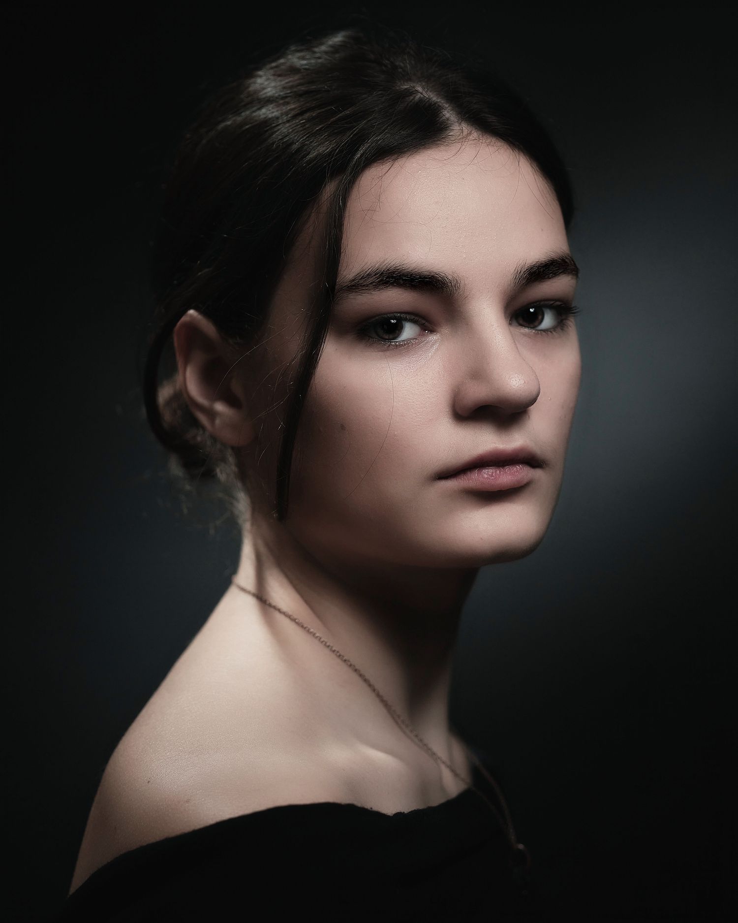 Intimate portrait series with soft side lighting creating dramatic shadows.