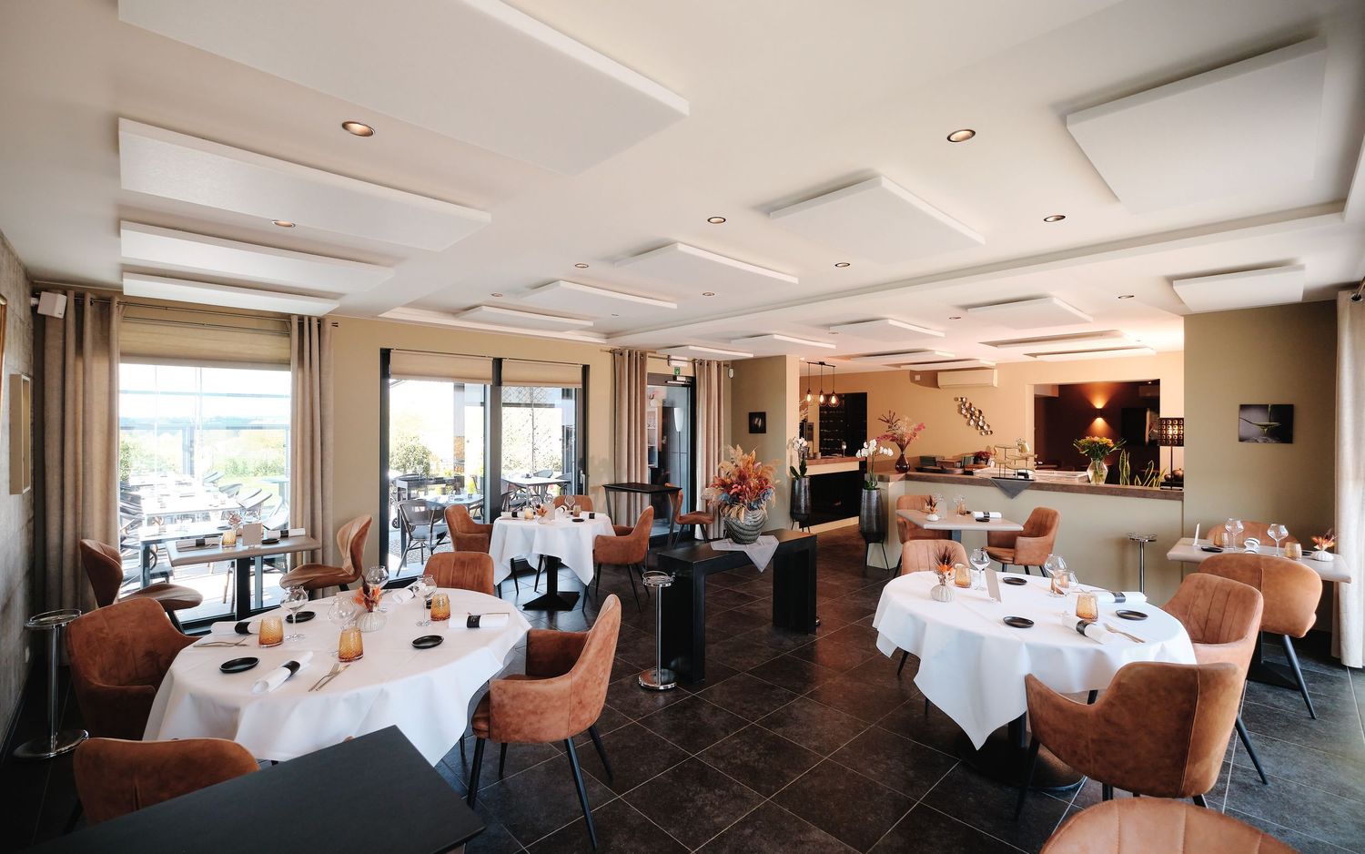 Panoramic view of a sophisticated dining room with white tablecloths and contemporary decor.