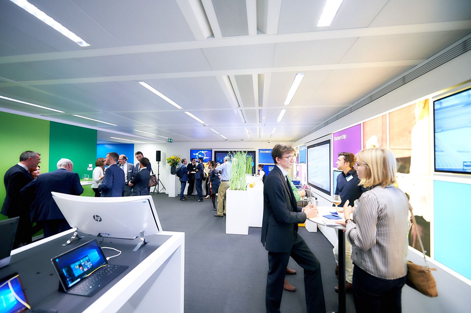 Modern office interior with colorful walls and technology displays.