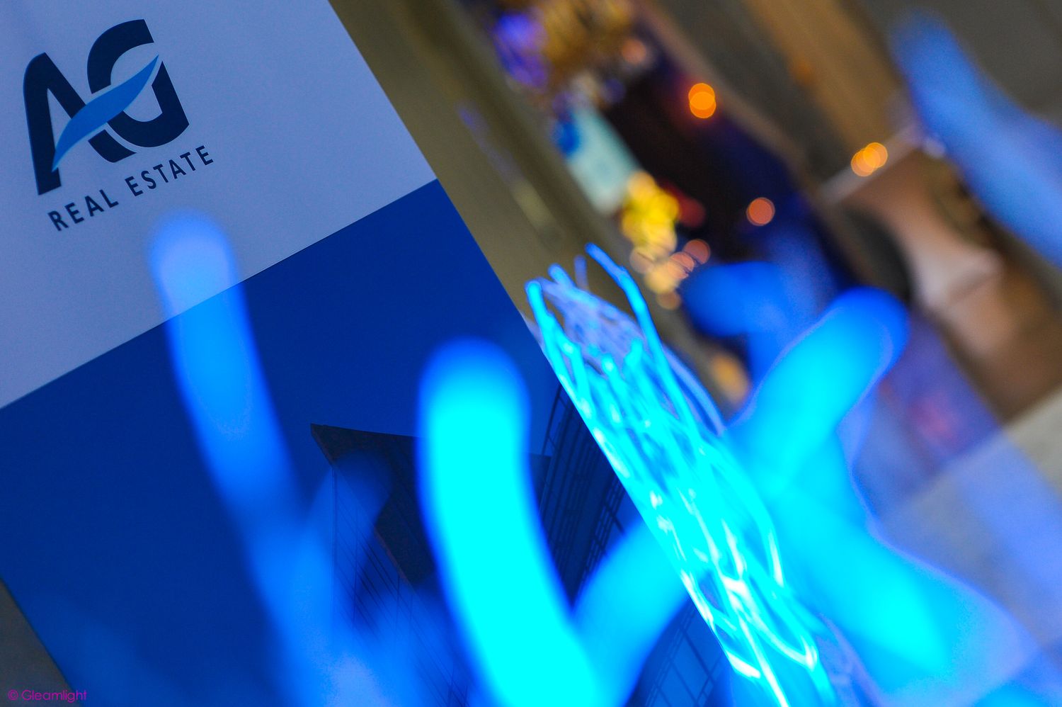 Abstract blue lighting effects against a dark background with corporate branding.