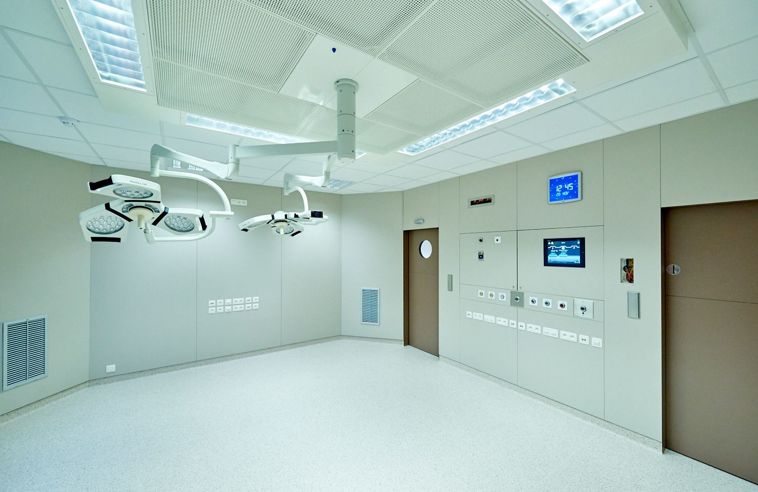 Clean modern medical facility with surgical lights and sterile white environment.