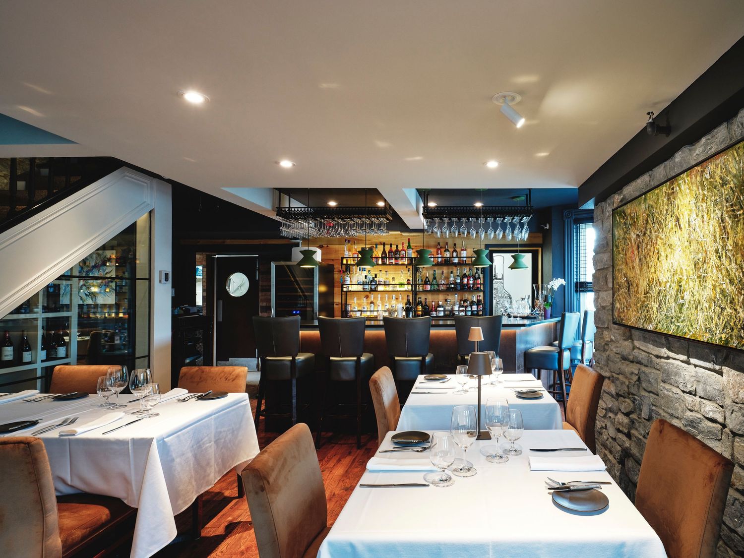 Modern fine dining restaurant interior with elegant table settings and ambient lighting.