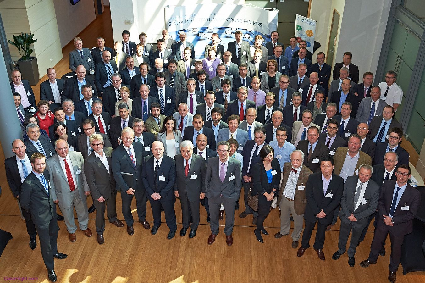 Large group photo of business professionals standing together at a corporate event.