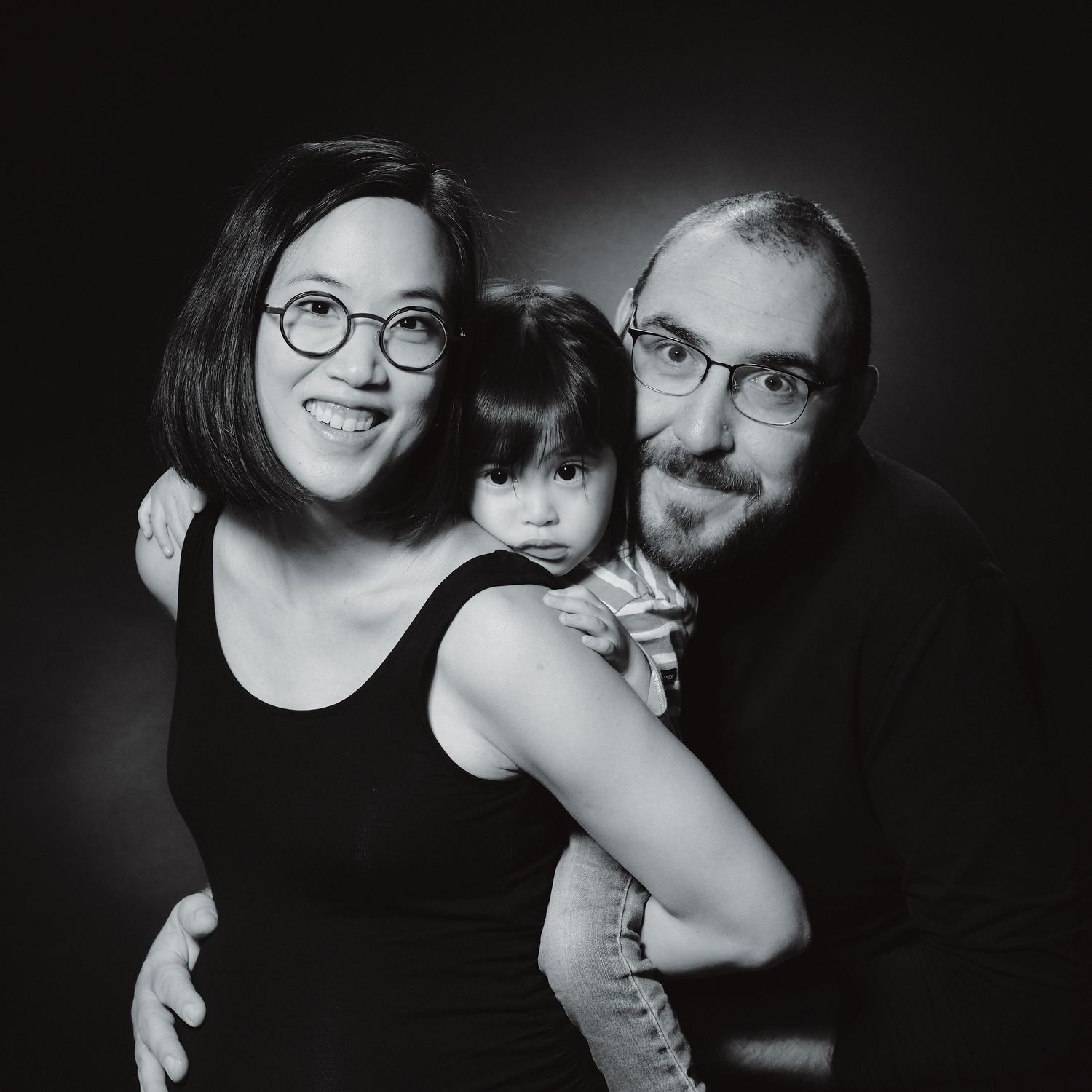 Intimate black and white family portraits showing loving embraces.