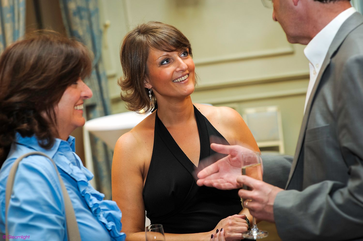 Professional networking event with attendees mingling in a formal setting.