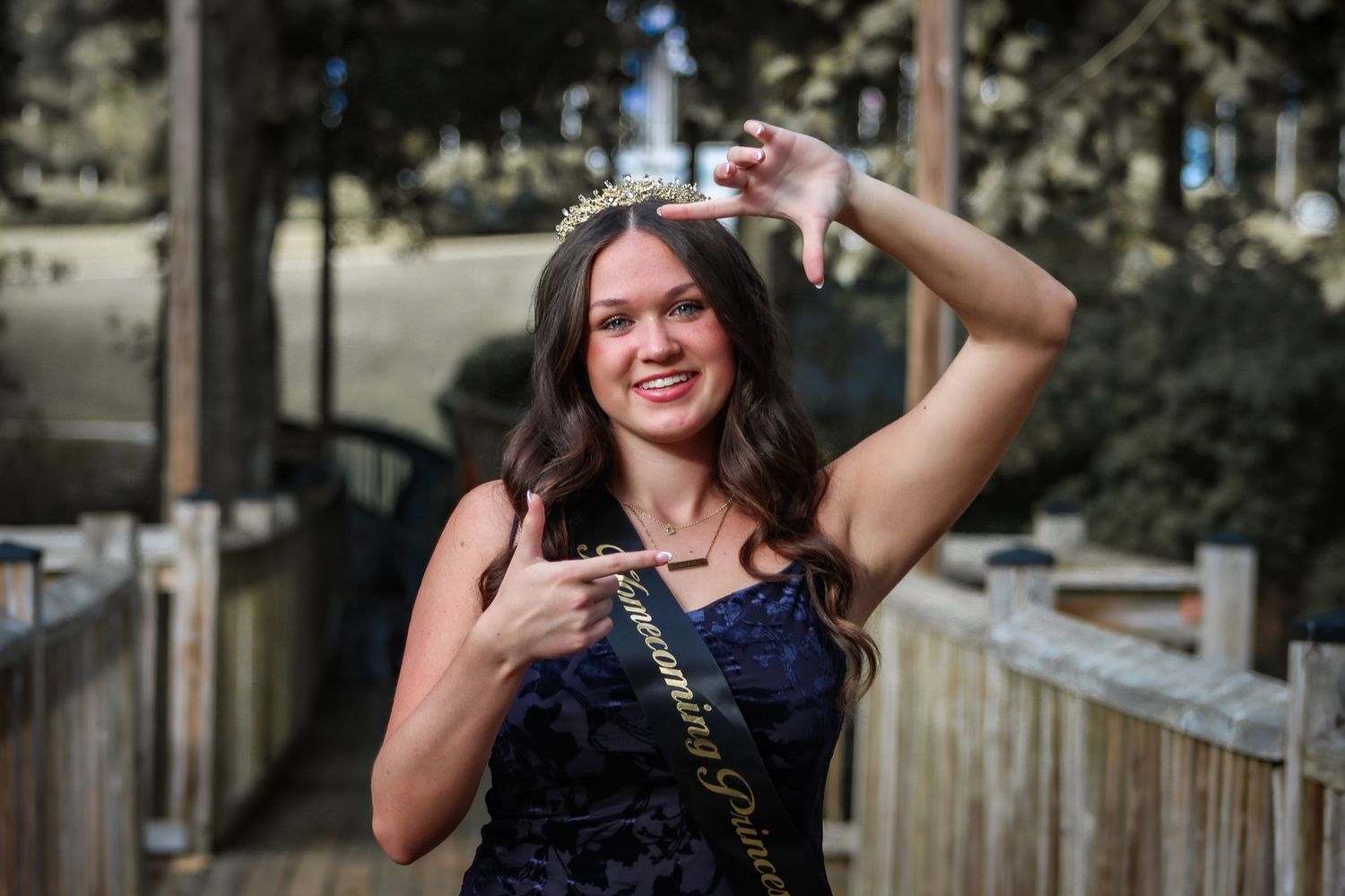 Homecoming queen portrait capture by L&C Moments in McDonough, GA - photography session showcasing her smile and elegant outfit.