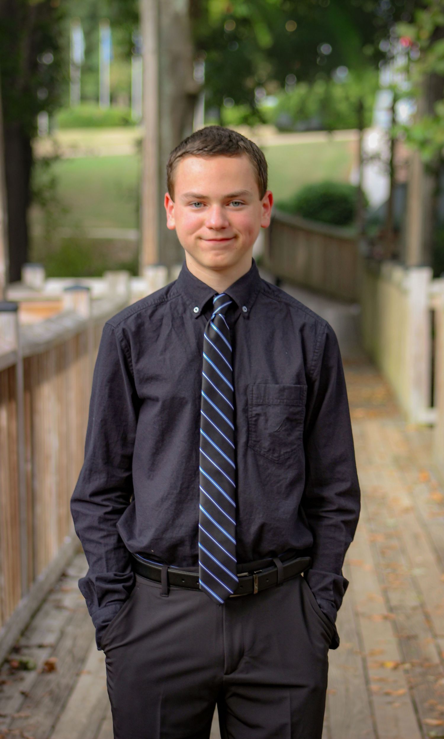 Homecoming portrait captured by L&C Moments Photography in McDonough, GA - session showcasing his smile and formal outfit.