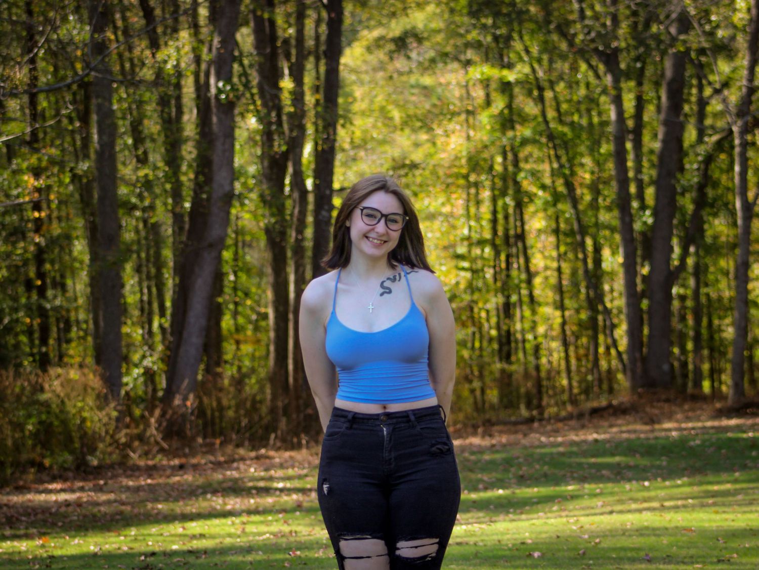Casual portrait of a girl in a field captured by L&C Moments Photography in McDonough, GA - session highlighting natural light and relaxed.