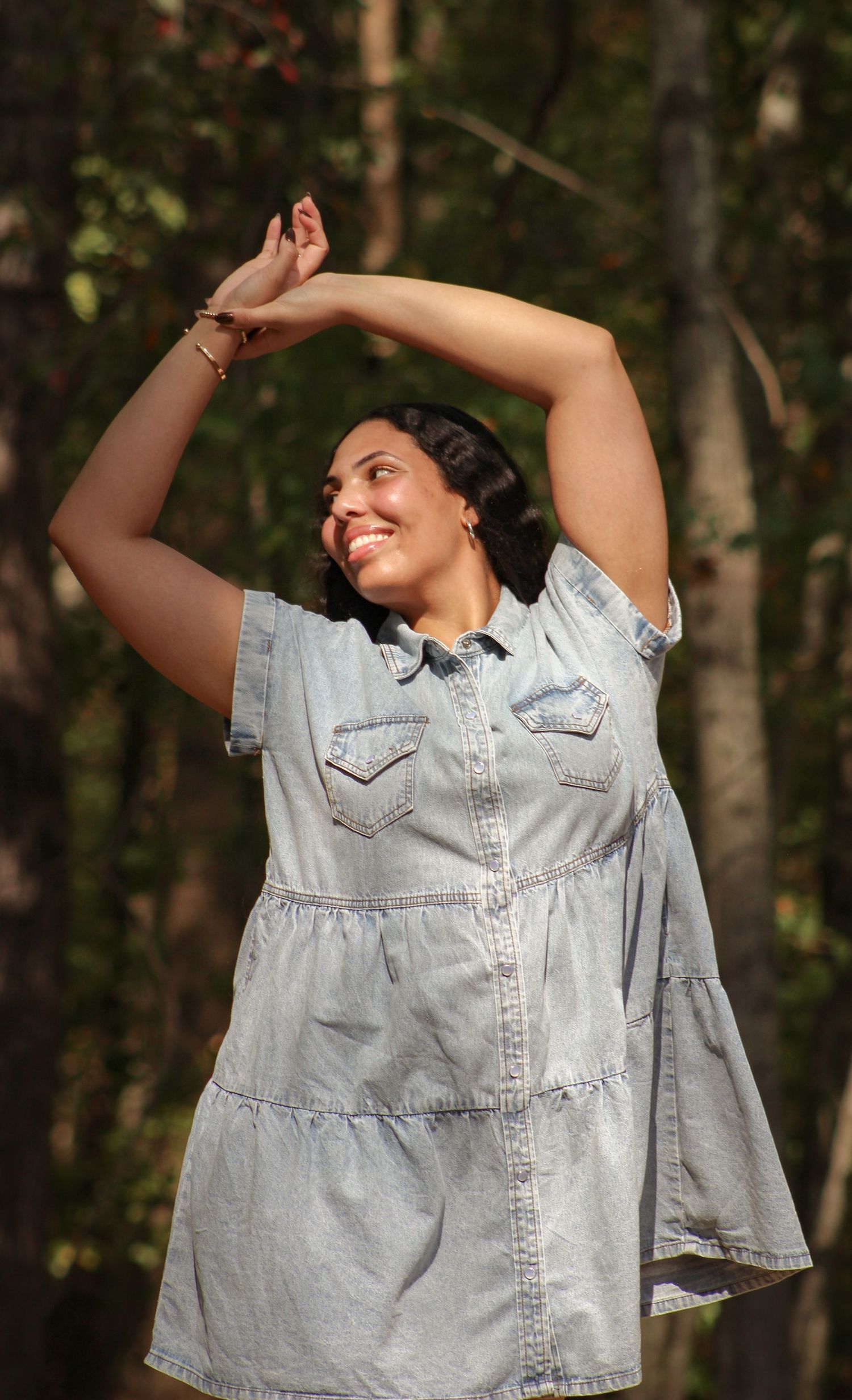 Portrait of smiling girl with hands up captured by L&C Moments Photography in McDonough, GA - highlighting joy, natural poses, and fun.