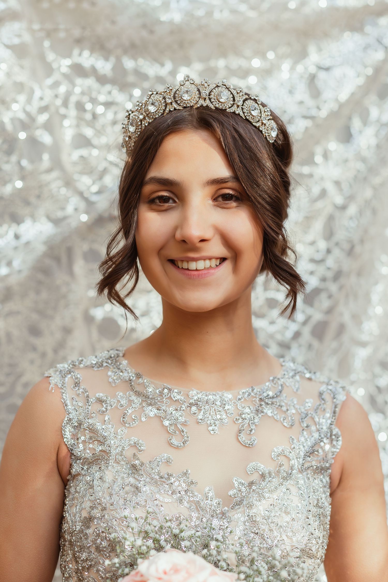 Bride wearing ornate crystal crown and beaded illusion neckline gown.