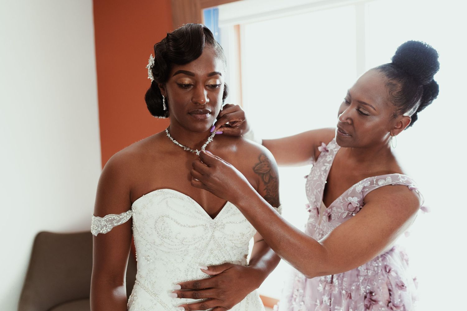 A heartwarming pre-wedding preparation moment in natural window light.