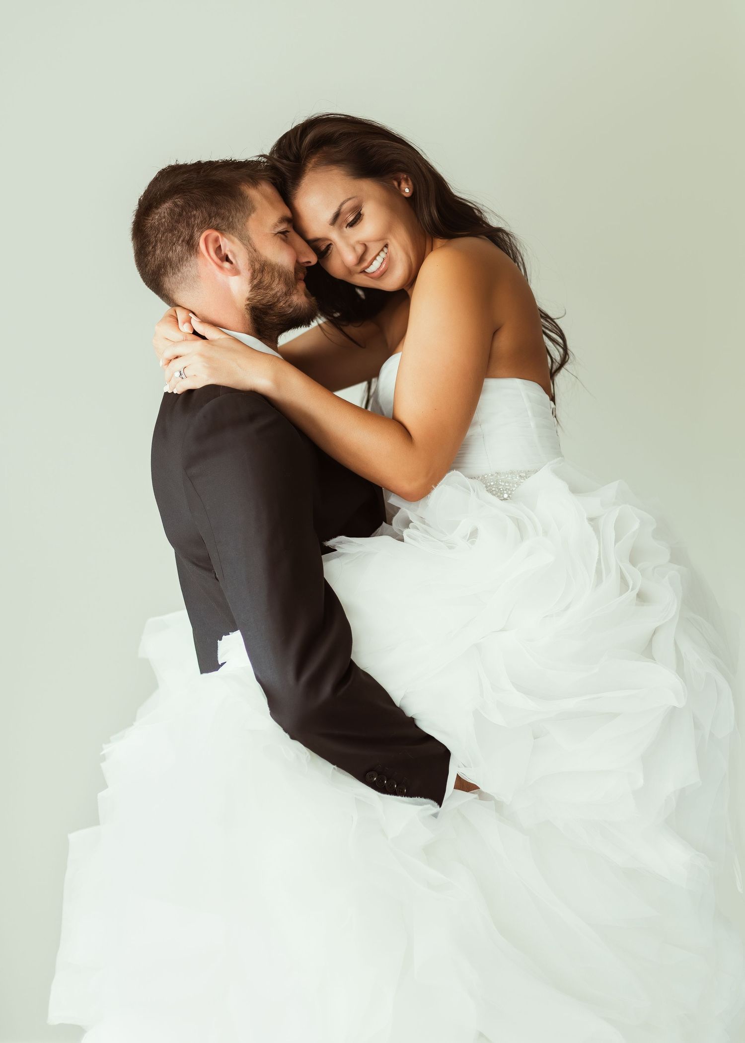 Artistic wedding photo capturing tender moment between newlyweds.