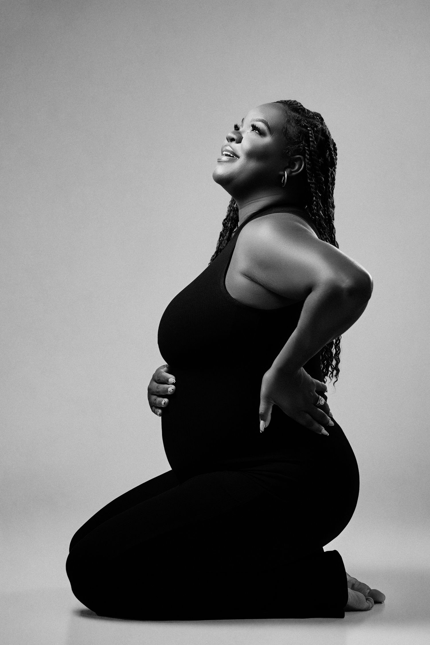 Black and white artistic portrait series showing graceful poses against minimalist background in dramatic lighting.