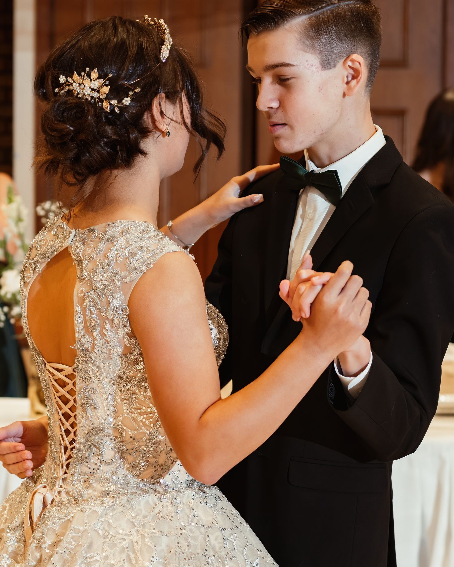 Intimate moment between newlyweds during first dance at wedding reception.