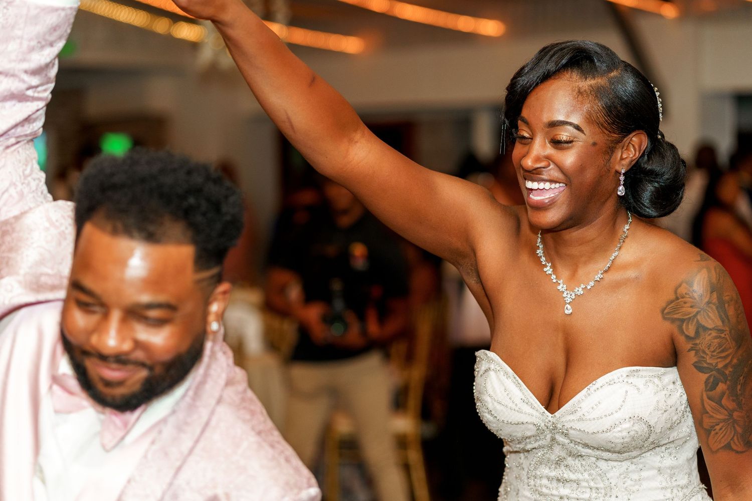 A joyous wedding celebration moment with dancing and laughter on the reception dance floor.